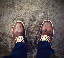 Drops of water on wet shoes. Man standing in the water