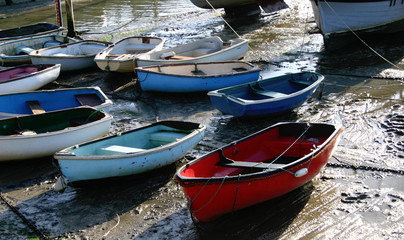 Fototapeta na wymiar Boats at low tide on the English coast, resting from countless hours at sea