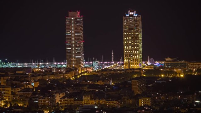 timelpase of the barcelona city skyline throughout the night.