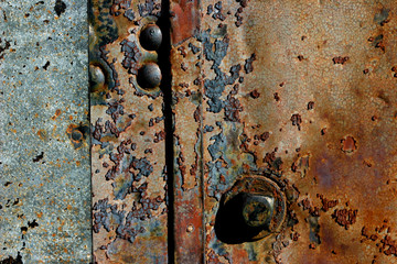 A detail of the steel door on a well used rail train car