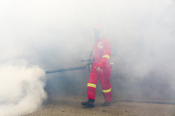 PUTRAJAYA, MALAYSIA - JULY 29, 2017 : Unidentified pest control operator from Ministry Of Helath Malaysia fogging to eliminate mosquito for preventing spread dengue fever and zika virus.