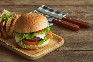 Homemade hamburger on plaid napkin with french fries. Delicious sandwich hamburger with meat or...