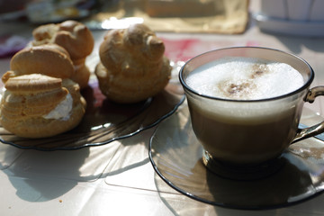Cup of coffee and eclairs
