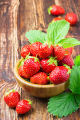 Ripe strawberry on wooden rustic table.  Space for text.