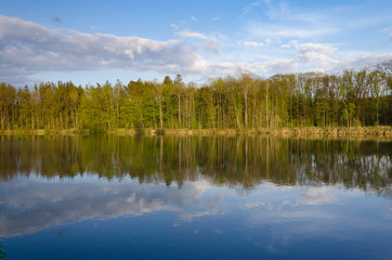 Sunset in the countryside with lake, forest an forest mirroring