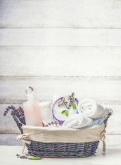 Basket with spa ,wellness or beauty setting on white wooden background, front view
