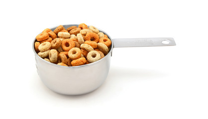 Multigrain hoops breakfast cereal in a measuring cup