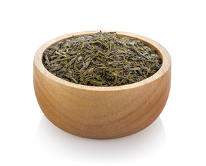 dried tea in wood bowl on white background