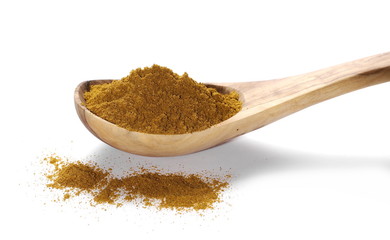Turmeric (Curcuma) powder pile in wooden spoon isolated on white background