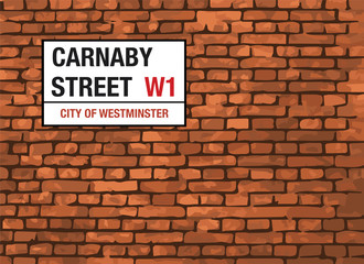 Fototapeta na wymiar Carnaby Street London Sign On A Brick Background