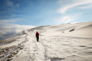 Mountain hiker in bad weather during winter © dziewul