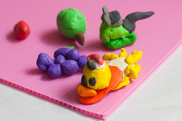 .Colorful plasticine on old paper in the house.