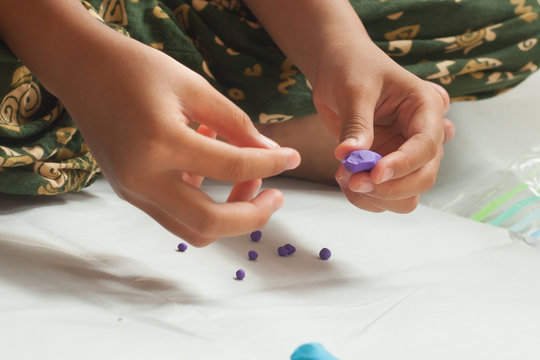 Child hands with plasticine in home at Thailand.