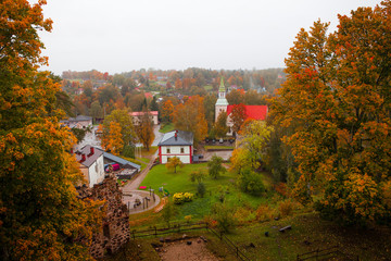 Fototapeta na wymiar Fall foliage and old European town view with the church