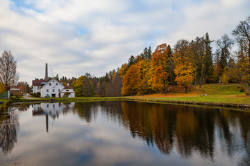 Fototapeta na wymiar Palmse distillery and hotel reflection in water of pond, Estonia
