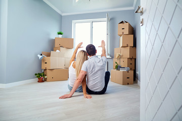 Young couple on the floor in a new house. Housewarming.
