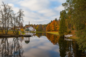 Fototapeta na wymiar Palmse distillery and hotel reflection in water of pond, Estonia. Autumn time.