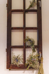 Beautiful scenery from an old window frame and dried flowers.