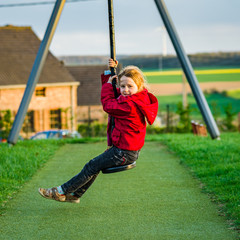 Cute little girl playing on children playground