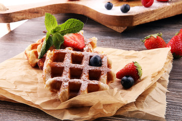 Traditional belgian waffles with fresh fruit and powder sugar
