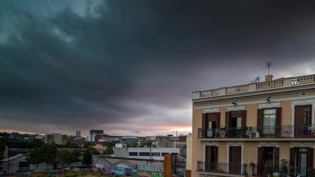 sunset timelapse shot of an apartment building surround by derelict land in the poblenou district of barcelona