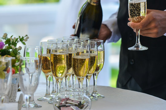 Waiter Serving Champagne On A Tray