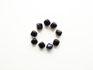 Tumbled Black Obsidian stones circle for crystal therapy treatments and reiki