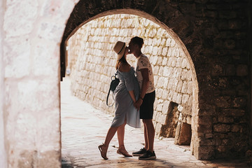 Fototapeta na wymiar happy loving couple with pregnant woman walking in Montenegro Kotor streets
