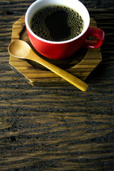 cup coffee red with wood spoon on wooden texture ground vintage