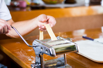 Man making homemade pasta at home
