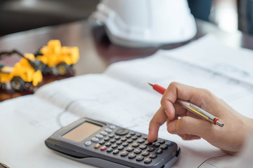 The engineer pressed the calculator on the desk.