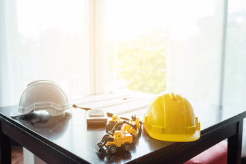 Drawings and hard hat on the desk