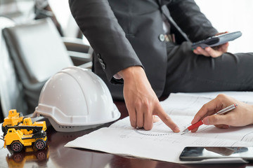 Architect sketching a construction project. engineer working on the desk.