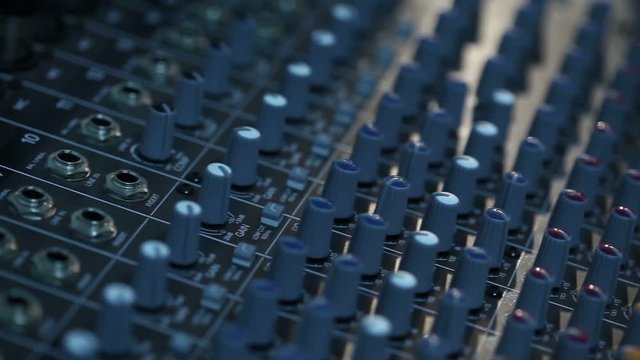 Professional audio console in a concert, sound mixer console during a concert, audio Mixer, control engineer, selective focus, audio mixer, shallow depth of field