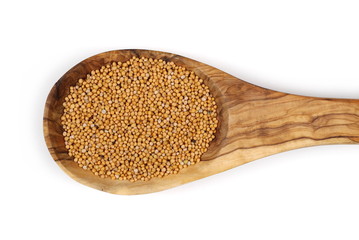 Yellow mustard seeds in wooden spoon isolated on white background, top view