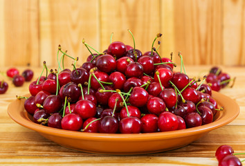 Tasty sweet cherry on wooden background