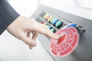 Woman pushing red or emergency button on dash board for stop machine..