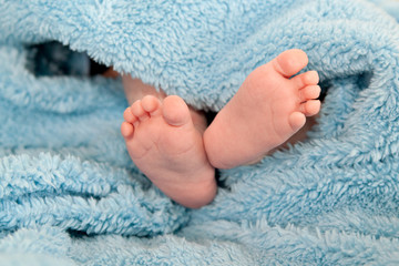 Cute infant heels in blue blanket