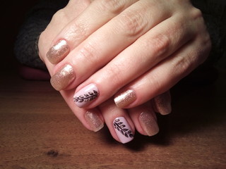 The manicurist excellently made her work a beautiful manicure with a polish gel on her hands and the client is happy