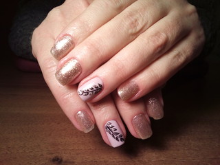 The manicurist excellently made her work a beautiful manicure with a polish gel on her hands and the client is happy