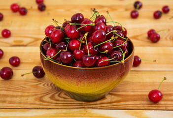 Tasty sweet cherry on wooden background