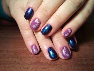 The manicurist excellently made her work a beautiful manicure with a polish gel on her hands and the client is happy