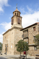 Fototapeta na wymiar a street and Nuestra Señora de la Asunción parish church in Caminreal, province of Teruel, Spain