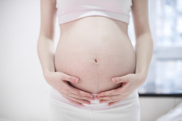 Pregnant woman relaxing at home on the couch