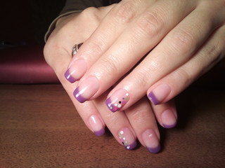 The manicurist excellently made her work a beautiful manicure with a polish gel on her hands and the client is happy