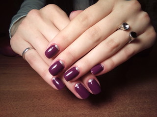 The manicurist excellently made her work a beautiful manicure with a polish gel on her hands and the client is happy