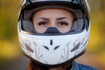 Close-up photo of girl in helmet with forest background