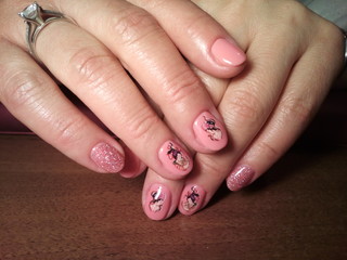 The manicurist excellently made her work a beautiful manicure with a polish gel on her hands and the client is happy