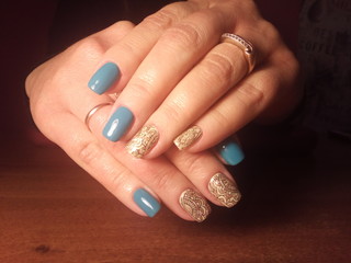 The manicurist excellently made her work a beautiful manicure with a polish gel on her hands and the client is happy