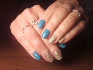 The manicurist excellently made her work a beautiful manicure with a polish gel on her hands and the client is happy